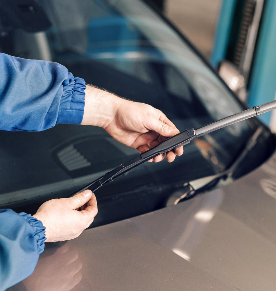 Staff checking a wiper blade for imperfections